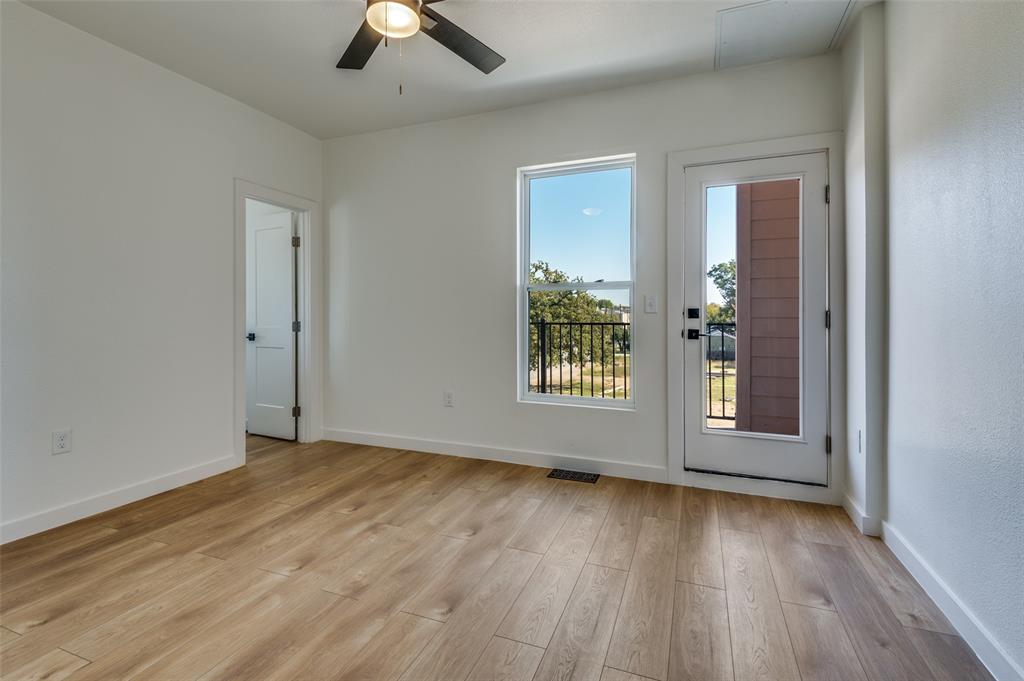 504 South O Connor Road Irving, TX 75060 - Photo 24 of 32 an empty room with wooden floor chandelier fan and windows