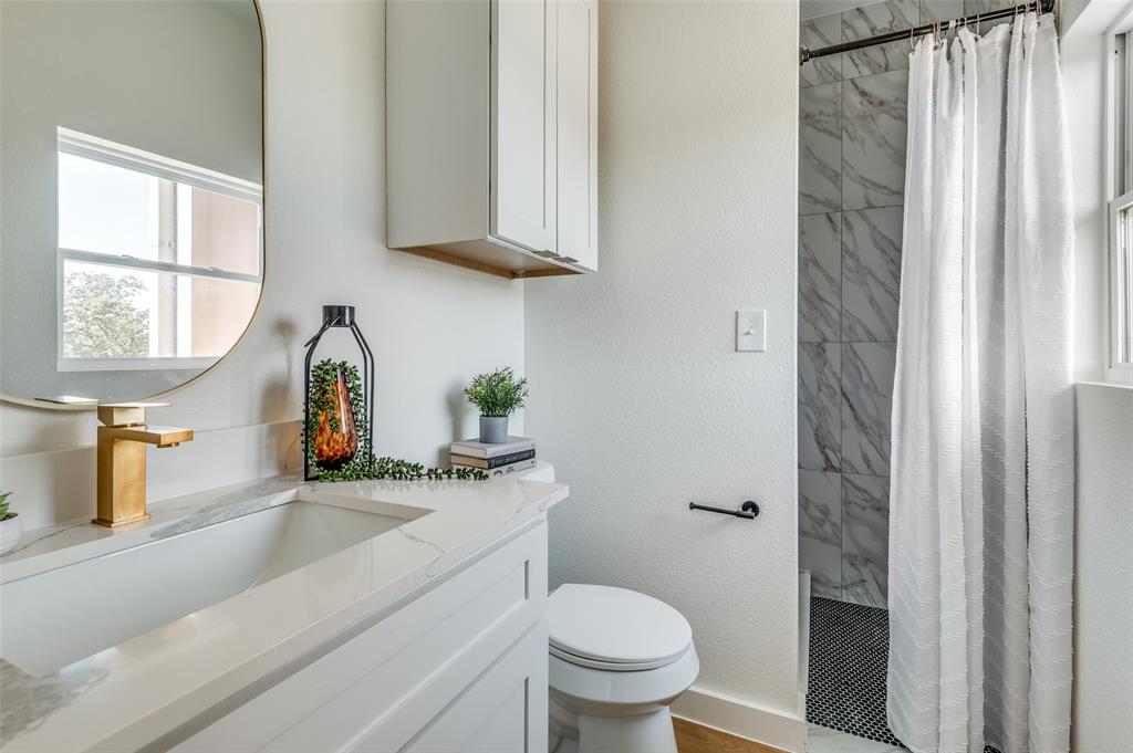504 South O Connor Road Irving, TX 75060 - Photo 25 of 32 a bathroom with a sink a toilet and window
