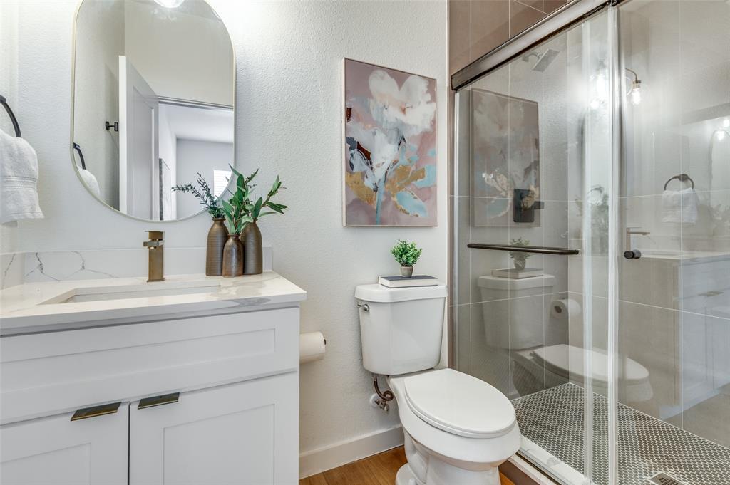 504 South O Connor Road Irving, TX 75060 - Photo 9 of 32 a white toilet sitting next to a bathroom sink