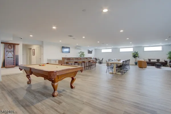 a room with lots of furniture wooden table and chairs