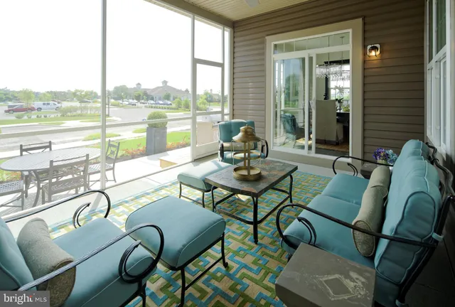 a living room with furniture and a floor to ceiling window