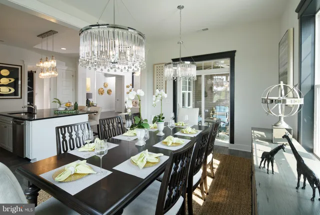 a view of a dining room with furniture a chandelier and wooden floor