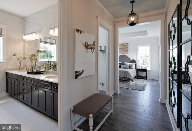 a hall way with wooden floor and staircase