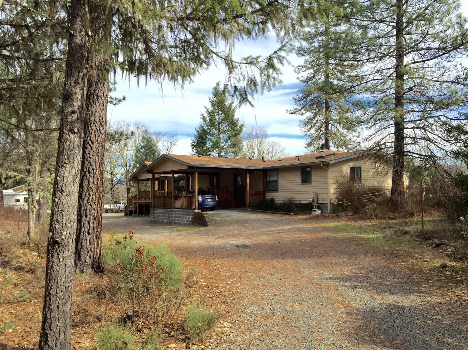 5707 Rockydale Road Cave Junction, OR 97523 - Photo 30 of 35 a front view of a house with a yard and garage