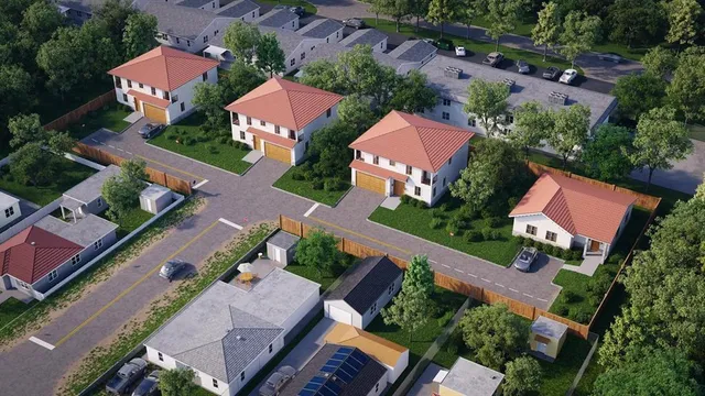 an aerial view of residential houses with outdoor space
