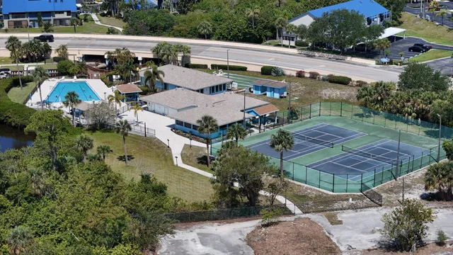 a patio with a table and chairs under an umbrella