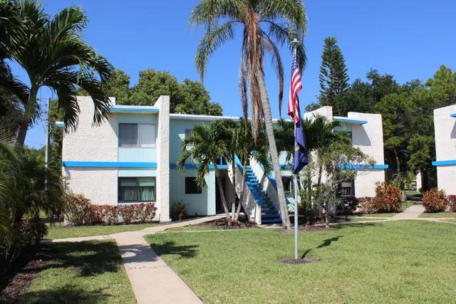 a view of a house with swimming pool and sitting area