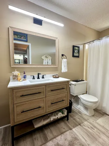 a spacious bedroom with a bed and a chandelier