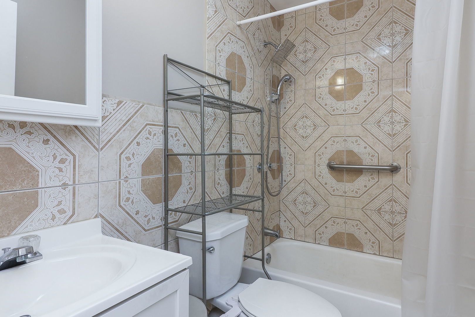 1222 Grove Street Aurora, IL 60505 - Photo 12 of 22 a bathroom with a sink toilet and shower