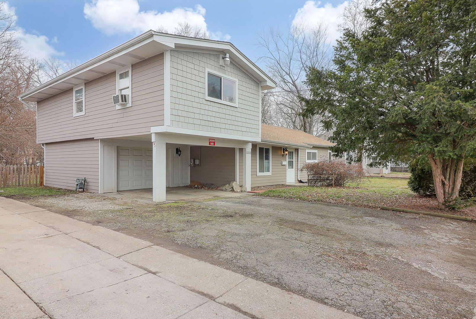 1222 Grove Street Aurora, IL 60505 - Photo 2 of 22 a front view of a house with a garden and trees