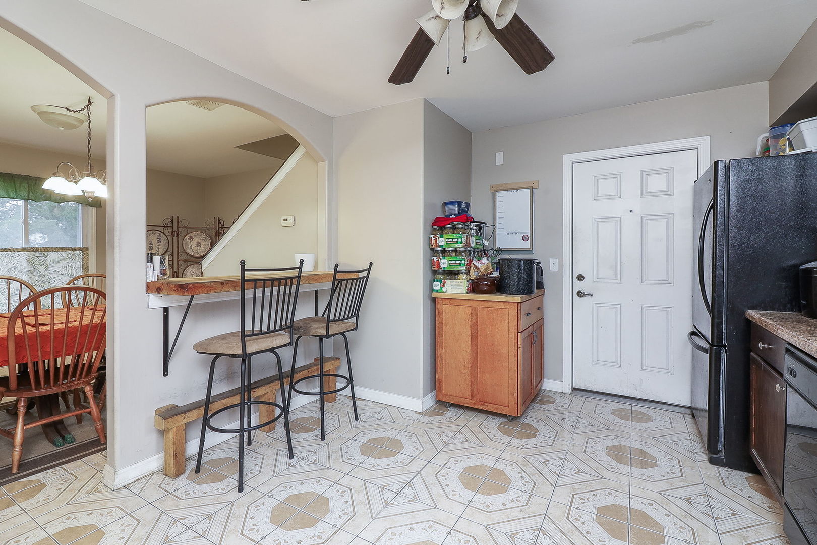 1222 Grove Street Aurora, IL 60505 - Photo 6 of 22 a dining room with furniture and a refrigerator