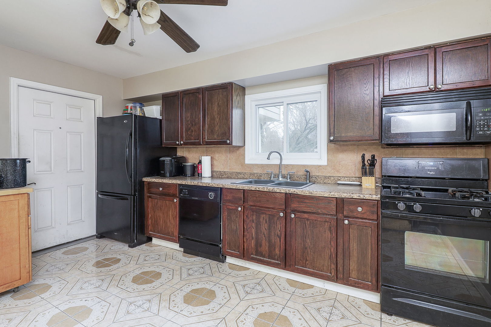 1222 Grove Street Aurora, IL 60505 - Photo 7 of 22 a kitchen with a sink stove and refrigerator