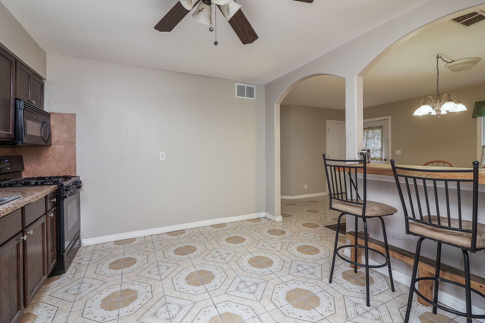 1222 Grove Street Aurora, IL 60505 - Photo 8 of 22 a view of a kitchen with a stove wooden floor and a kitchen view