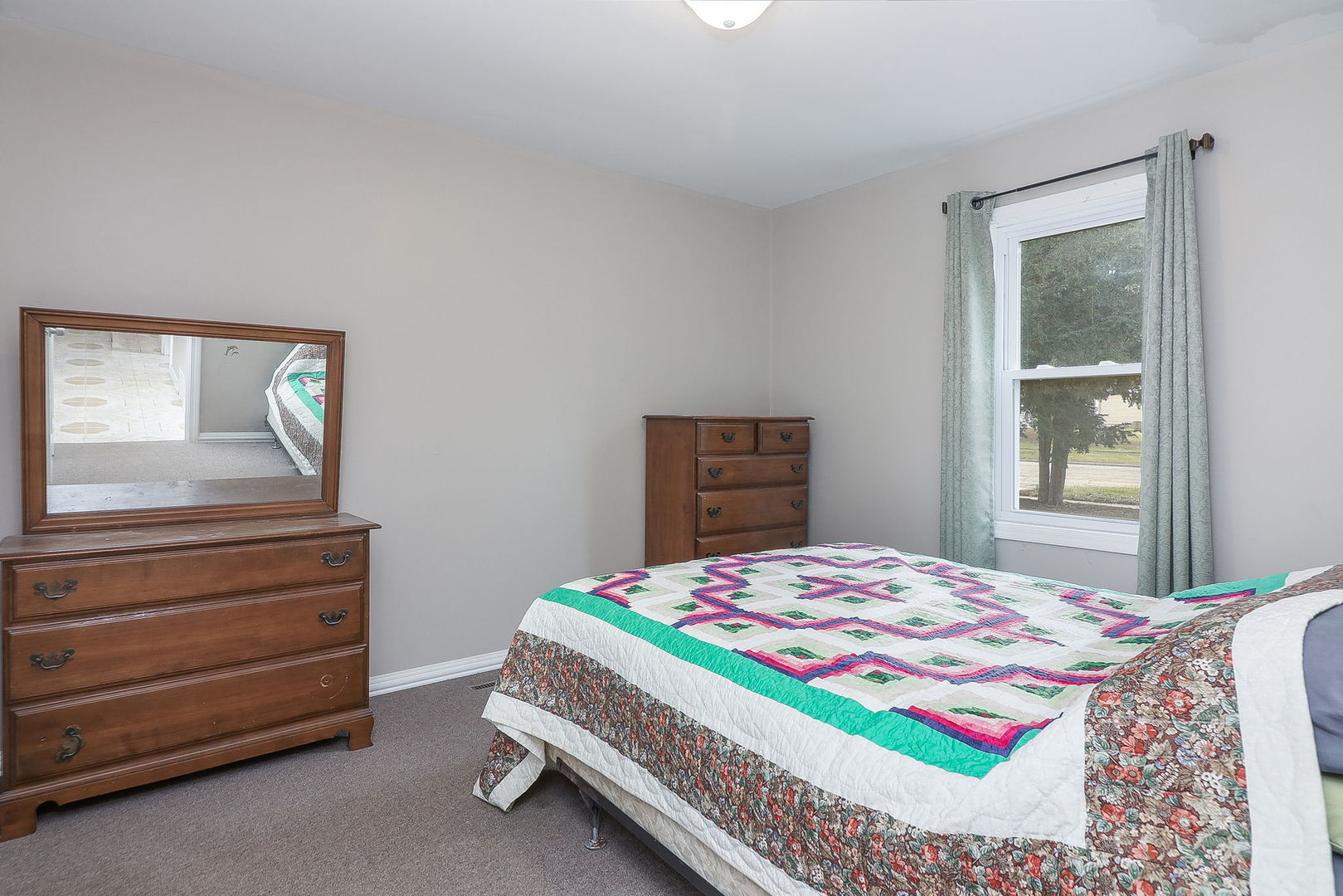 1222 Grove Street Aurora, IL 60505 - Photo 9 of 22 a bedroom with a bed and a dresser
