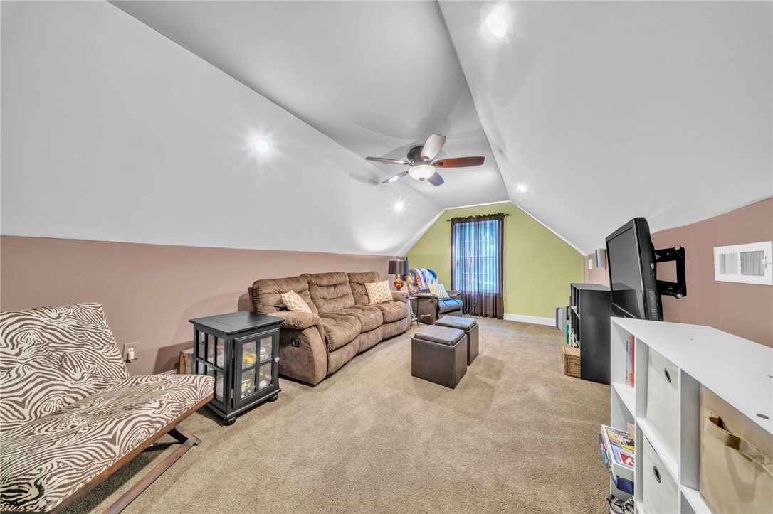 648 Mountain View Road Williamston, SC 29697 - Photo 27 of 42 A well-lit, versatile bonus room with sloped ceilings and plush carpeting provides an ideal adaptable space.