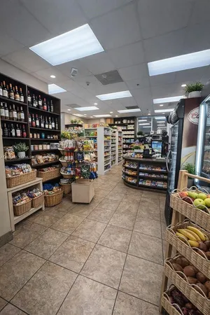 a open kitchen with stainless steel appliances granite countertop a refrigerator a sink a stove and a refrigerator