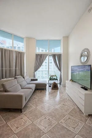 a living room with furniture and a large window