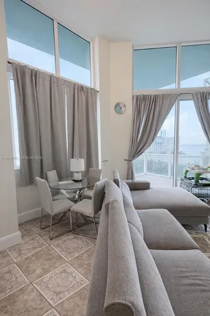 a bedroom with a bed and flat screen tv