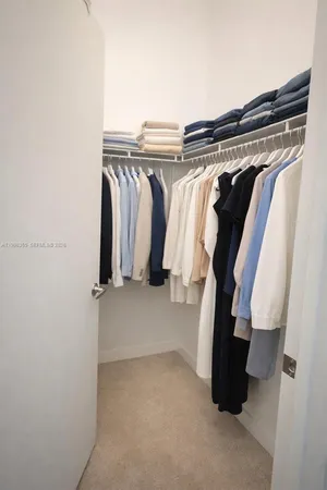 a kitchen with stainless steel appliances granite countertop a sink and a refrigerator