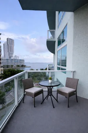 a view of a balcony with two chairs and a table