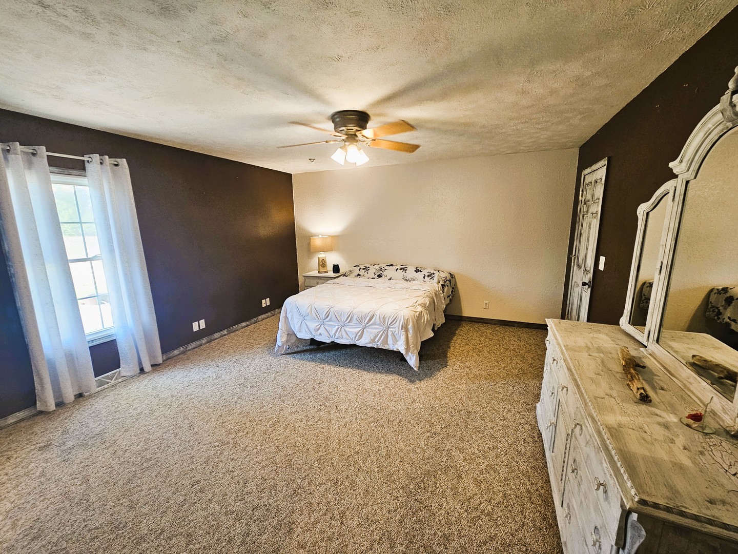 878 County Road 600N Sims, IL 62886 - Photo 26 of 39 a spacious bedroom with a bed and a chandelier