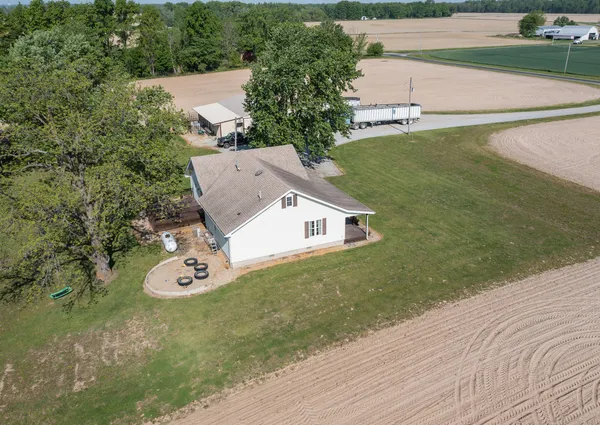 an aerial view of a house with a yard