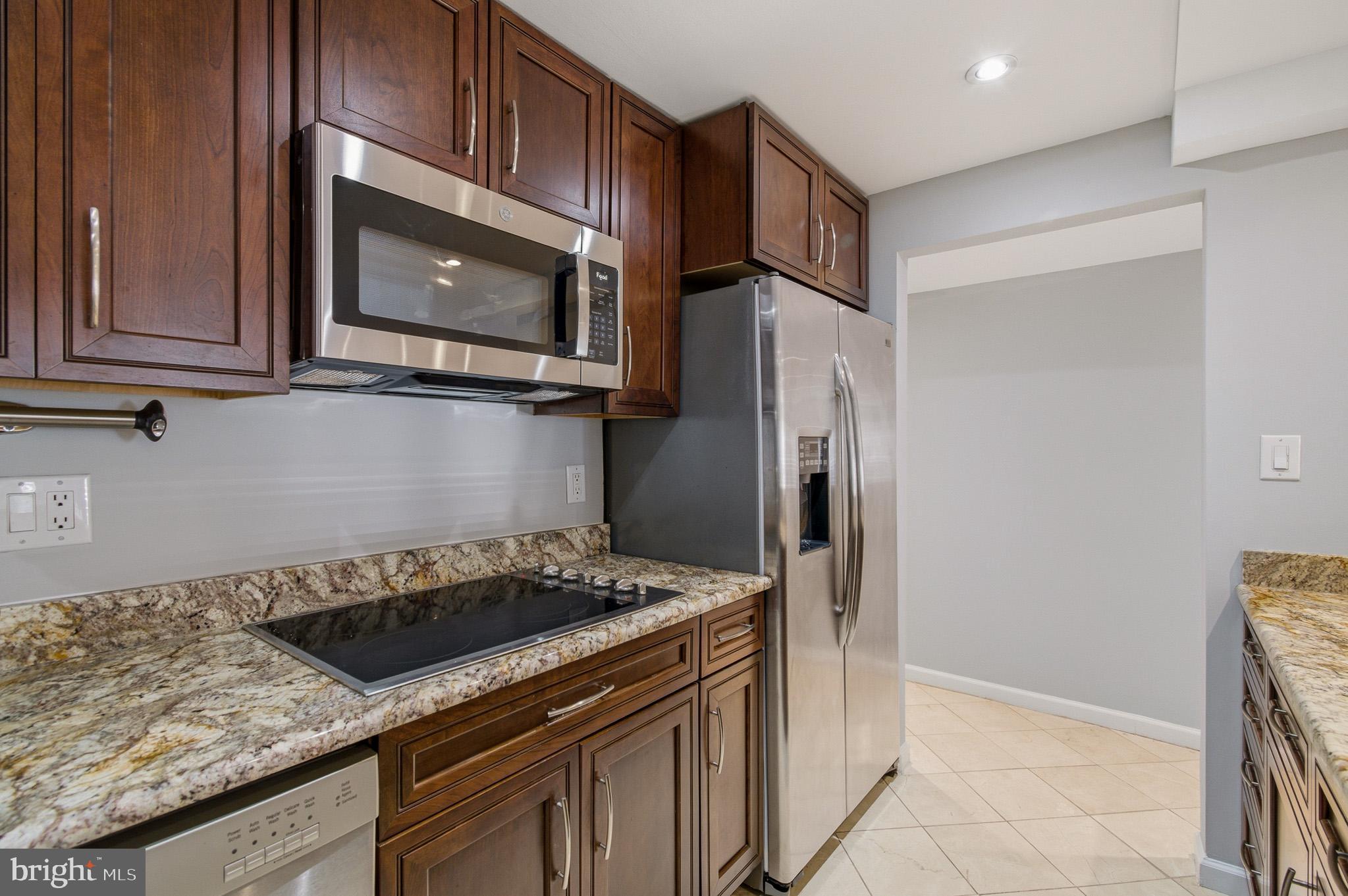 2117 S Street Northwest Washington, DC 20008 - Photo 36 of 63 a kitchen with a stove microwave and refrigerator