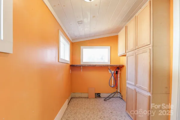 a view of a hallway with wooden shelves