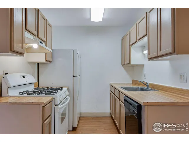 a kitchen with stainless steel appliances granite countertop a stove a refrigerator and a cabinets