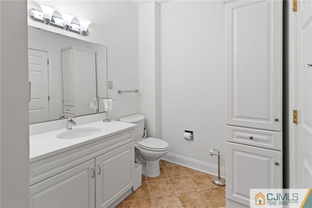2126 Windrow Drive Plainsboro, NJ 08540 - Photo 14 of 32 a bathroom with a sink a toilet and mirror