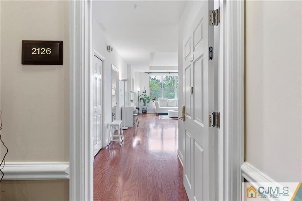 2126 Windrow Drive Plainsboro, NJ 08540 - Photo 17 of 32 a view of a hallway with wooden floor and living room