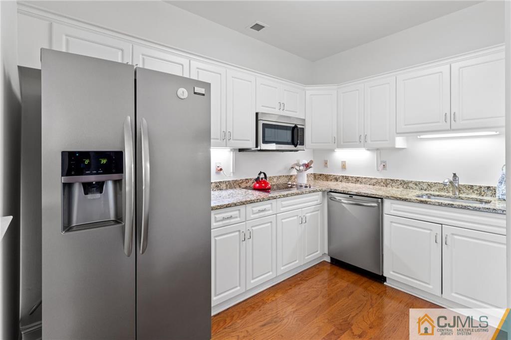 2126 Windrow Drive Plainsboro, NJ 08540 - Photo 6 of 32 a kitchen with cabinets stainless steel appliances and a counter space
