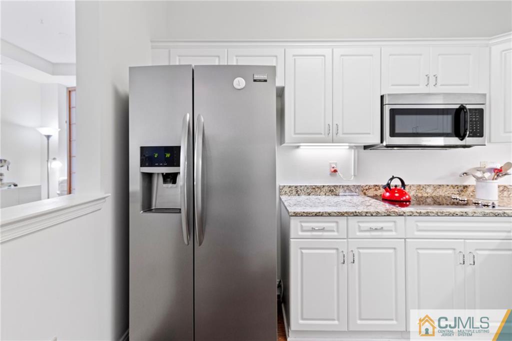 2126 Windrow Drive Plainsboro, NJ 08540 - Photo 7 of 32 a kitchen with white cabinets and refrigerator