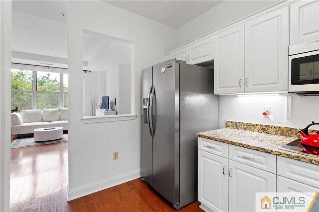 2126 Windrow Drive Plainsboro, NJ 08540 - Photo 9 of 32 a kitchen with stainless steel appliances granite countertop a refrigerator sink and white cabinets
