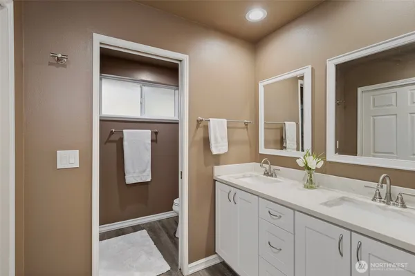 a bathroom with a double vanity sink and mirror
