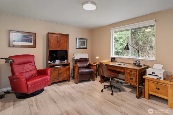 a living room with furniture a rug and a large window