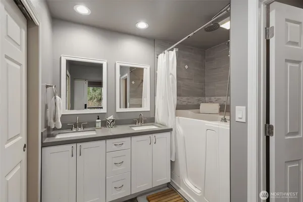 a bathroom with a granite countertop sink mirror and double