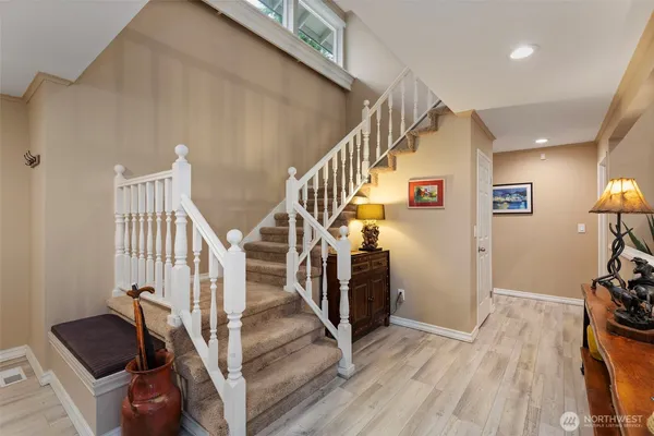 a view of entryway and hall with wooden floor