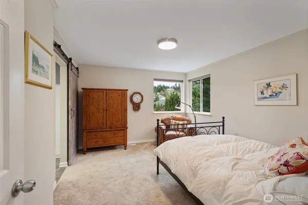 a bed sitting in a bedroom next to a window