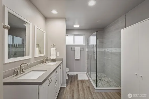 a bathroom with a granite countertop sink a shower and a mirror