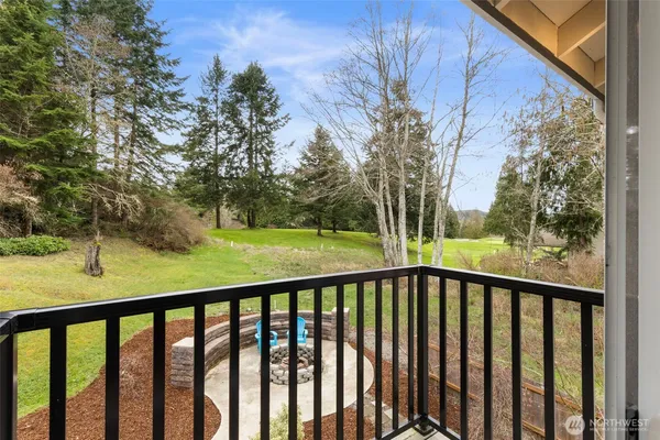a view of a balcony with a yard