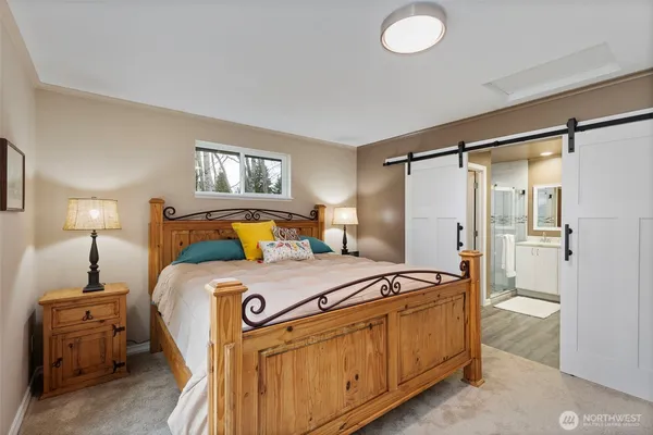 a bedroom with bed and a window