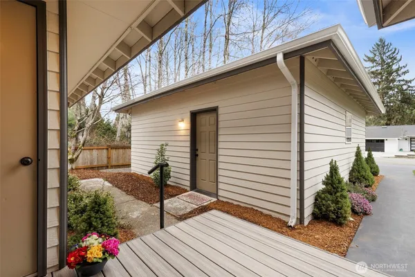 a view of a porch with furniture and wooden floor