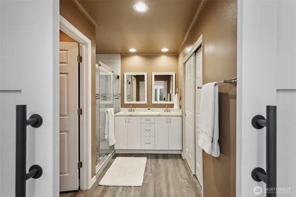 a bathroom with shower and a mirror