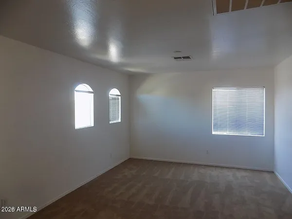 an empty room that has a window in it