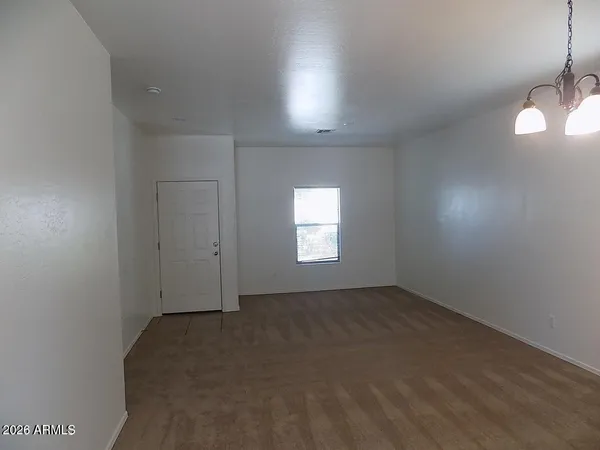 an empty room with a empty space and windows