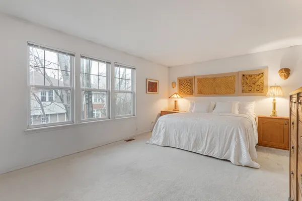 a bedroom with a bed and window