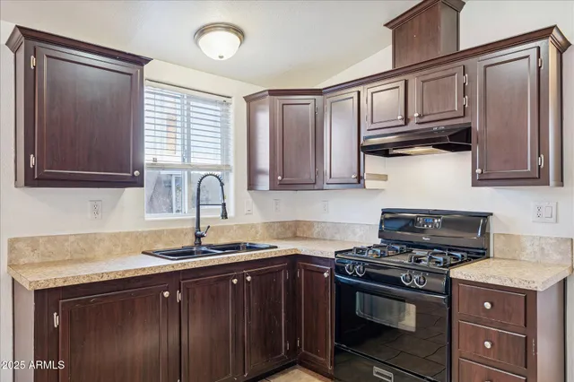 a kitchen with stainless steel appliances granite countertop a stove and a sink