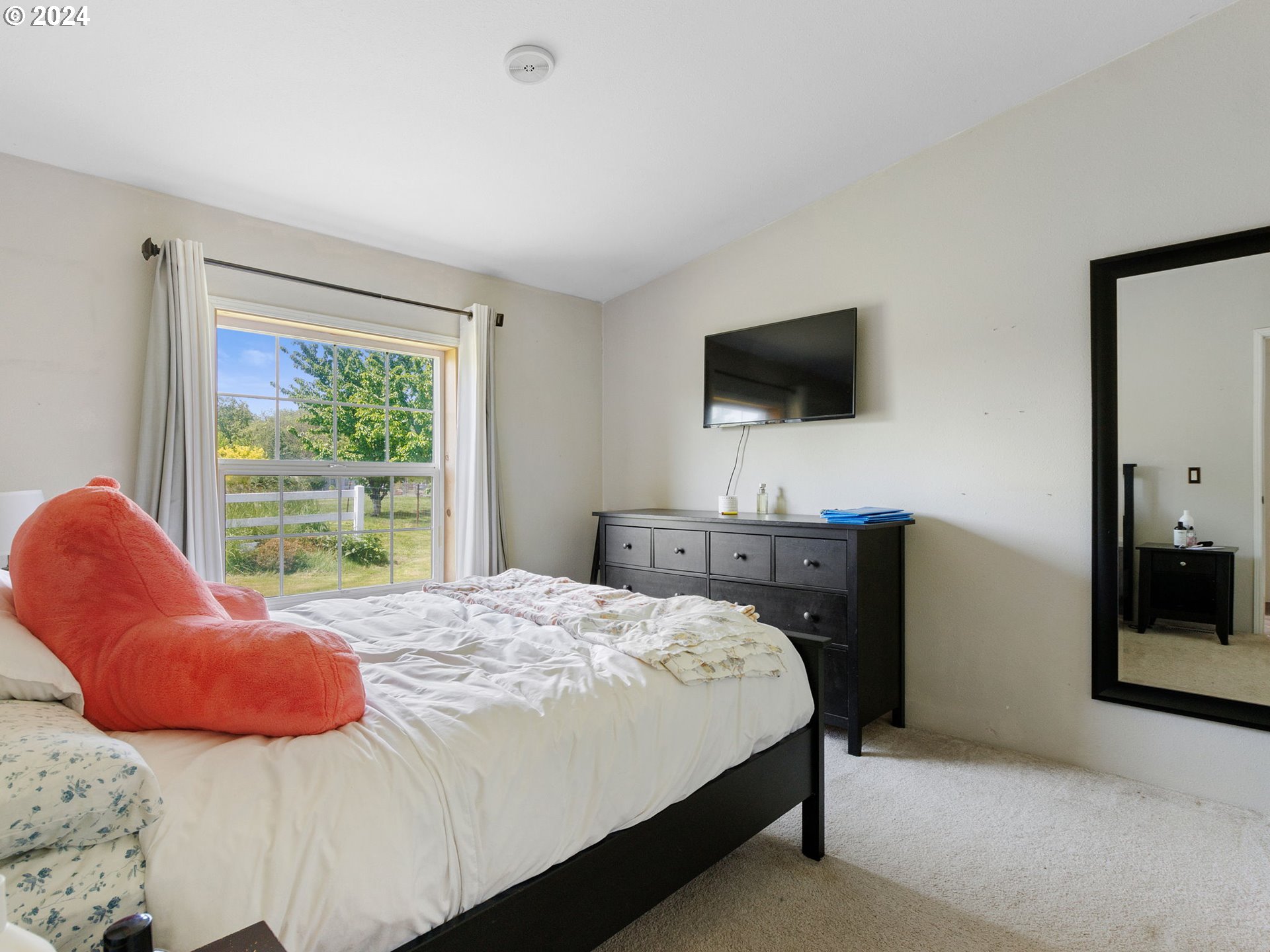 20221 Northeast 22nd Avenue Ridgefield, WA 98642 - Photo 12 of 39 a bedroom with a bed and a television