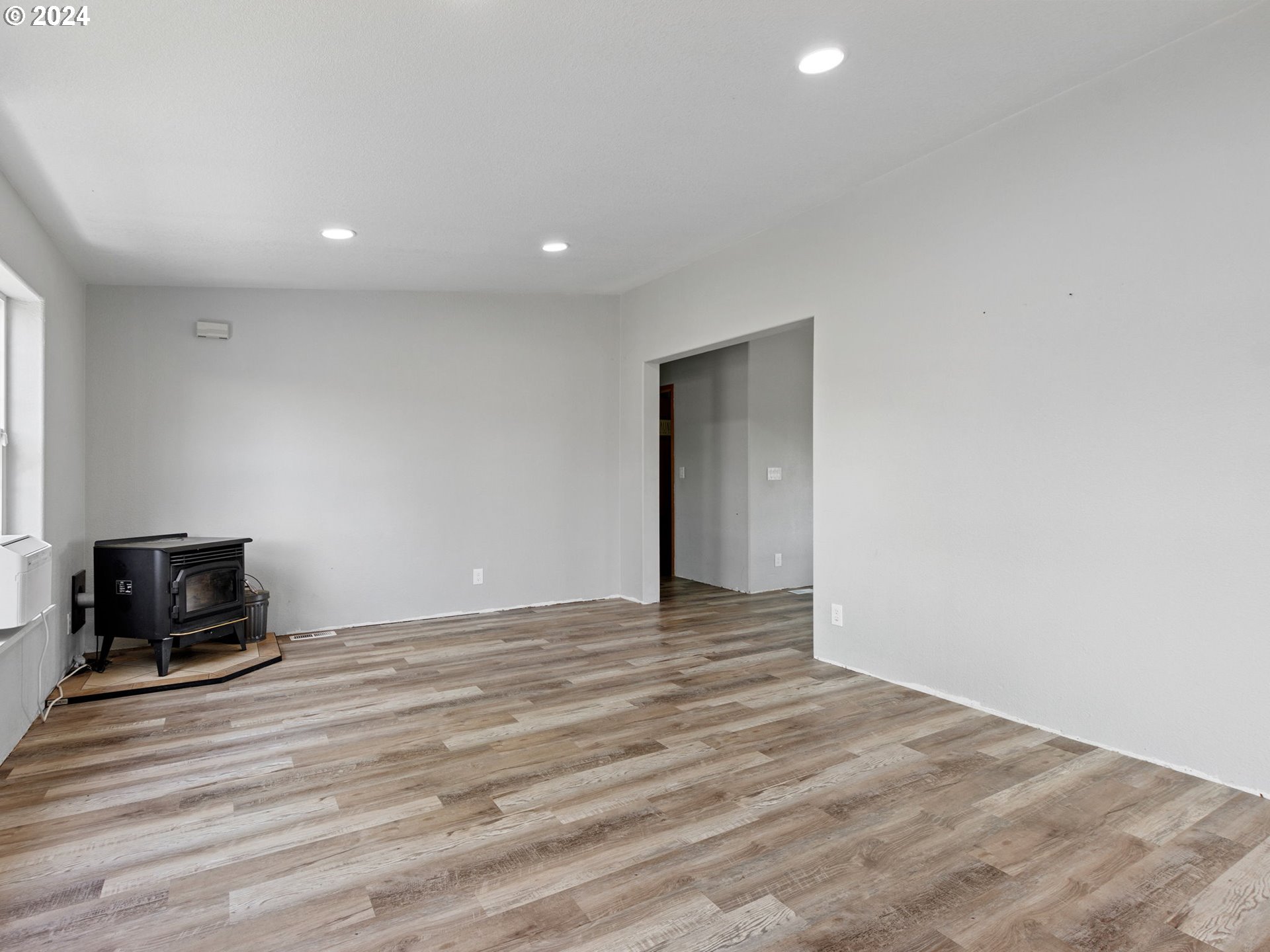 20221 Northeast 22nd Avenue Ridgefield, WA 98642 - Photo 18 of 39 a view of an empty room with wooden floor and a window